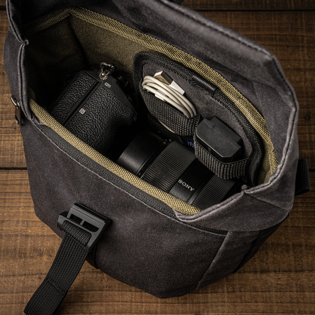 Wotancraft Pilot 3.5L black bag open with a Sony camera, lens and cable organiser