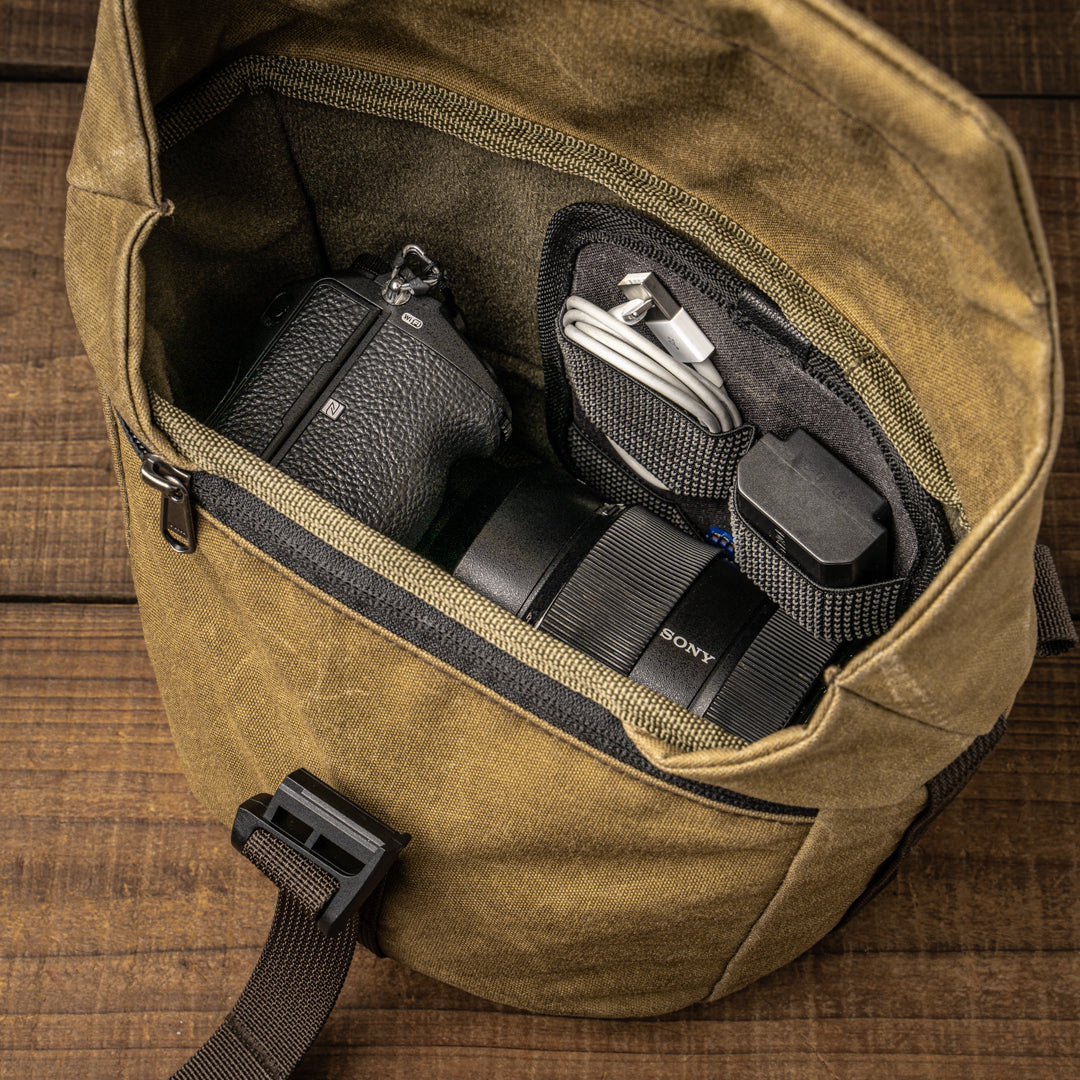 Wotancraft Pilot 3.5L khaki bag holding a Sony camera and lens in the insert