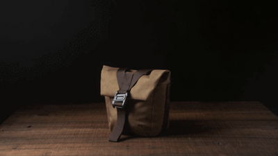 Wotancraft Pilot 3.5L khaki bag on a wooden table, front view