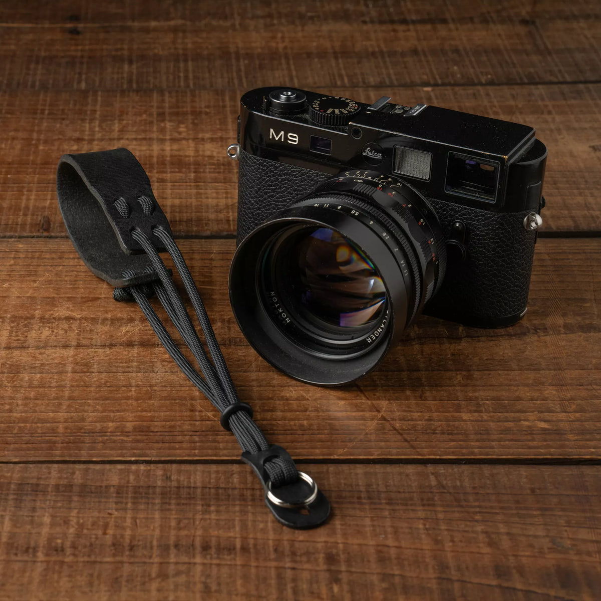 Wotancraft Parashooter Style 13 black wrist strap next to a black Leica M9