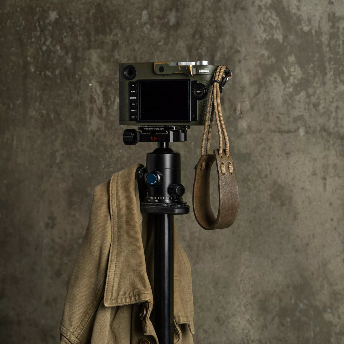 Olive Leica M on a tripod with the Wotancraft Parashooter olive wrist strap