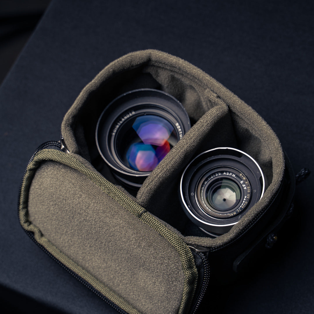 Wotancraft black leather pouch open with two rangefinder lenses and divider