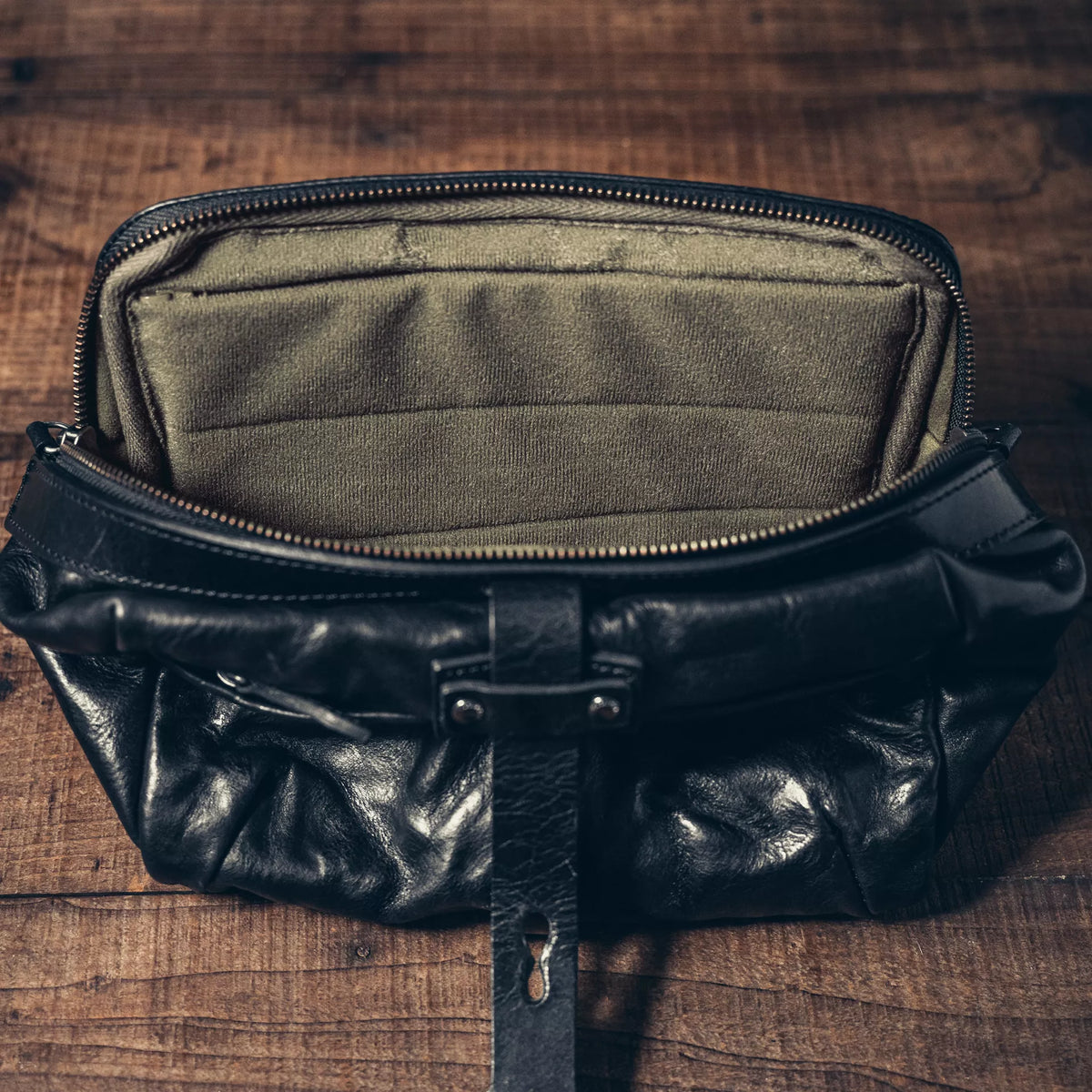 Wotancraft Mini Rider black leather bag open, showing the olive canvas lining