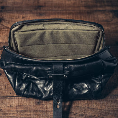 Wotancraft Mini Rider black leather bag open, showing the olive canvas lining