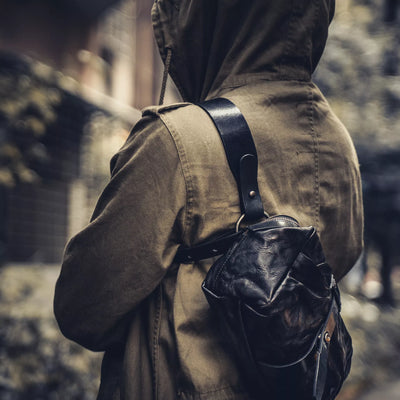 Wotancraft Mini Rider black leather sling worn across the shoulder, side view