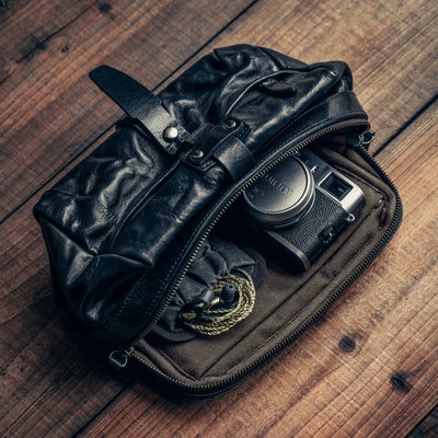 Wotancraft Mini Rider black leather bag open with a Fujifilm X100 camera inside