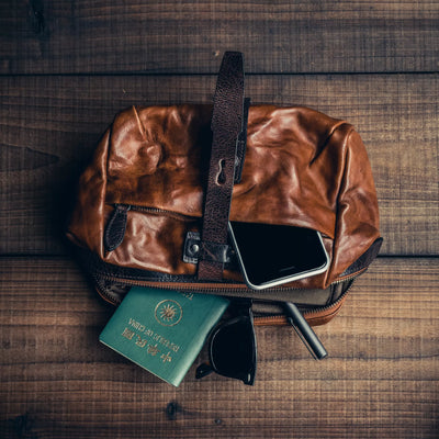 Wotancraft Mini Rider brown leather bag with passport, phone and sunglasses