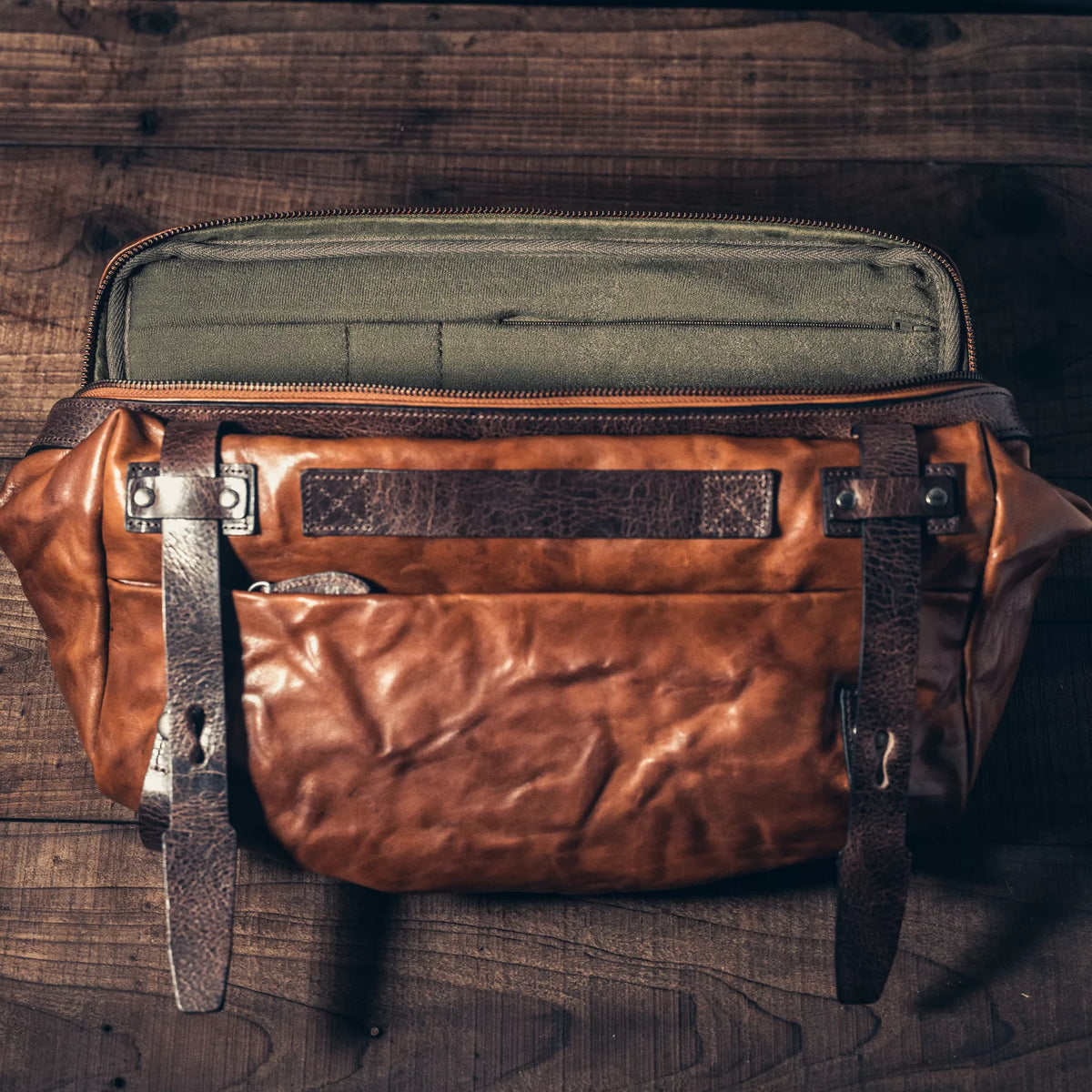 Wotancraft Night Rider brown leather bag open from above, showing the olive lining