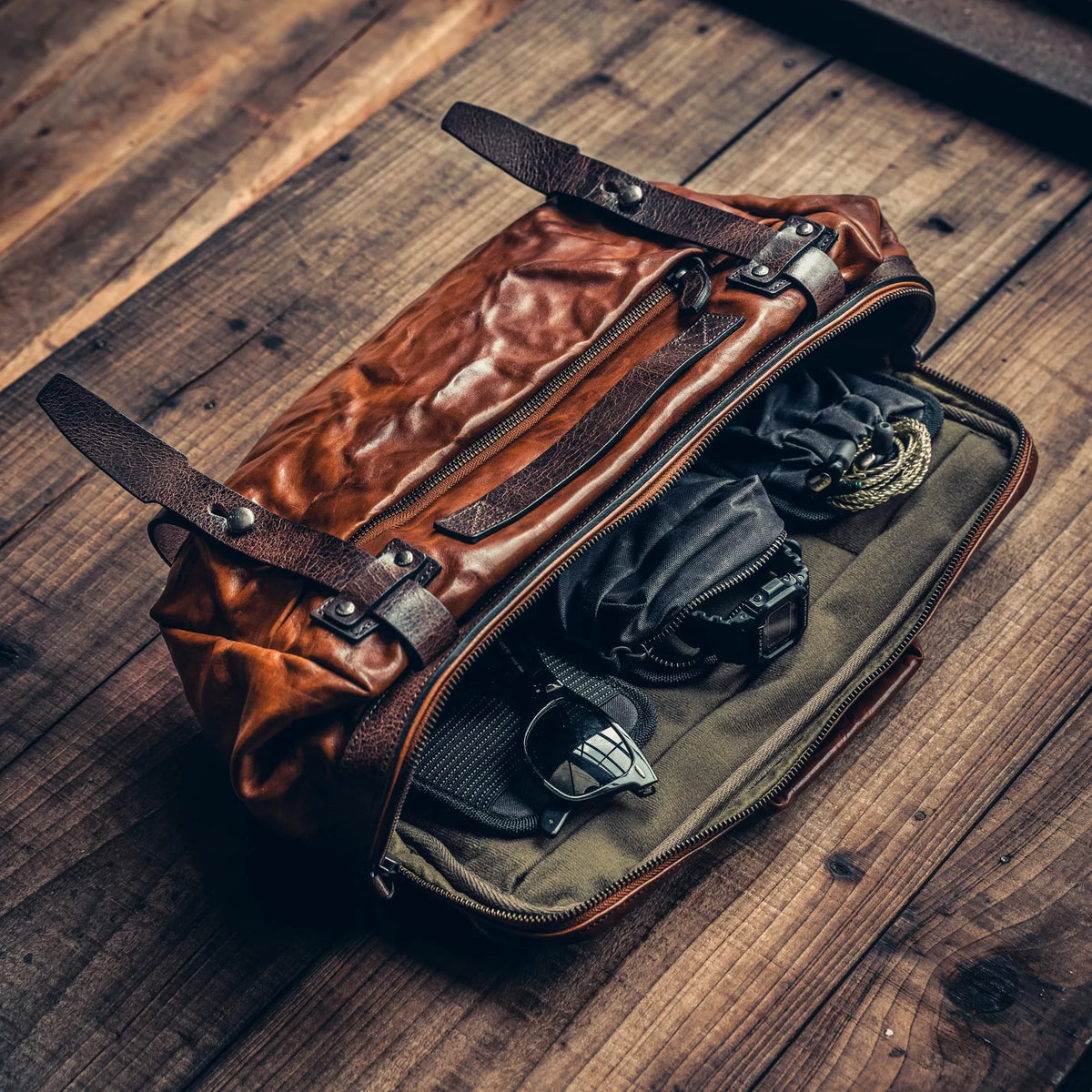 Wotancraft Night Rider brown leather bag open with camera pouch and sunglasses