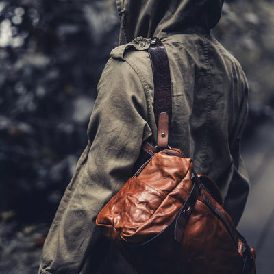 Person in a hooded jacket wearing the Wotancraft Lightning Rider brown leather bag