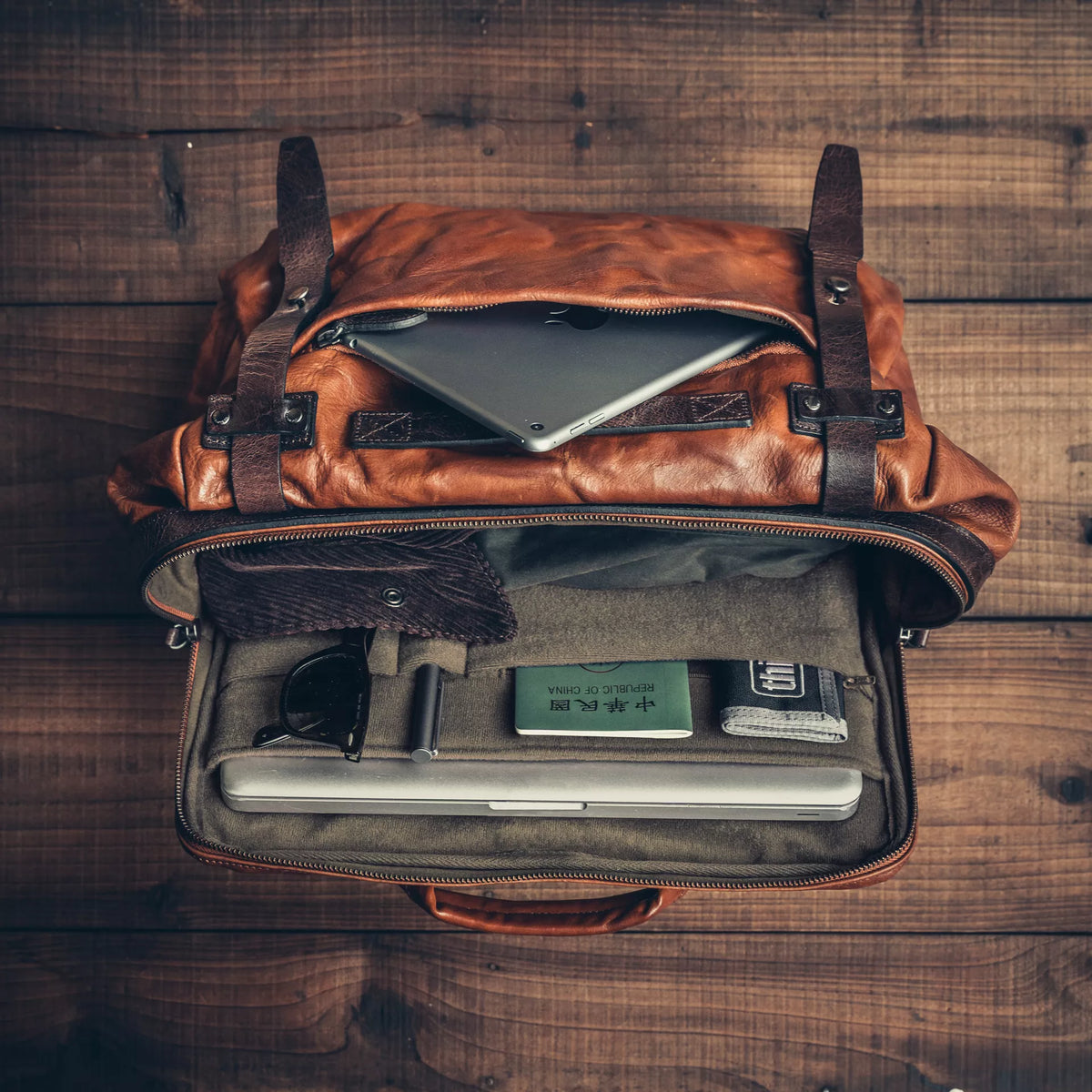 Wotancraft Lightning Rider brown leather bag from above with tablet, passport and laptop