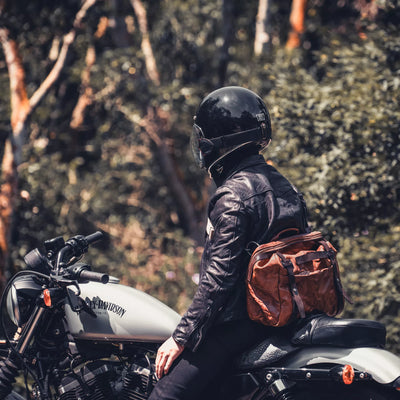 Motorcyclist on a Harley-Davidson wearing the Wotancraft Lightning Rider brown leather bag