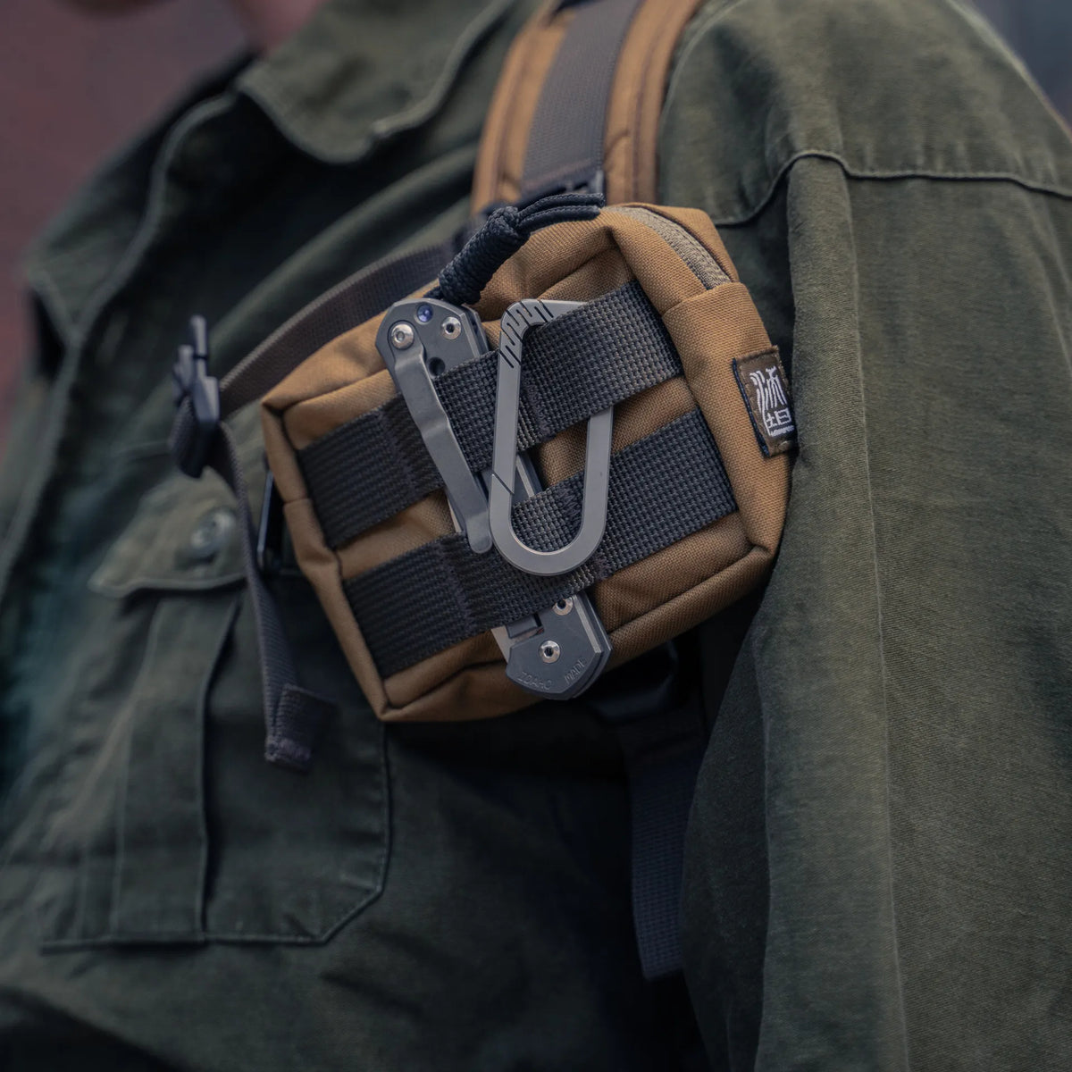 Wotancraft Armor small pocket on a backpack strap with a knife and carabiner