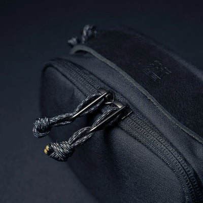 Wotancraft black canvas pouch double zip pulls with paracord, close-up