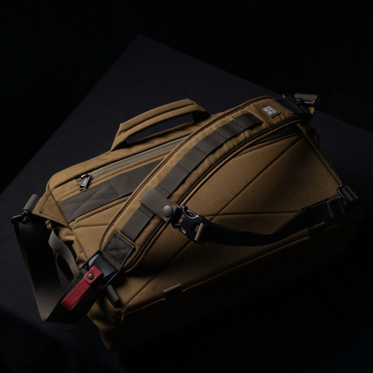 Wotancraft Lightning Rider v2 khaki bag with shoulder strap, top view on dark background