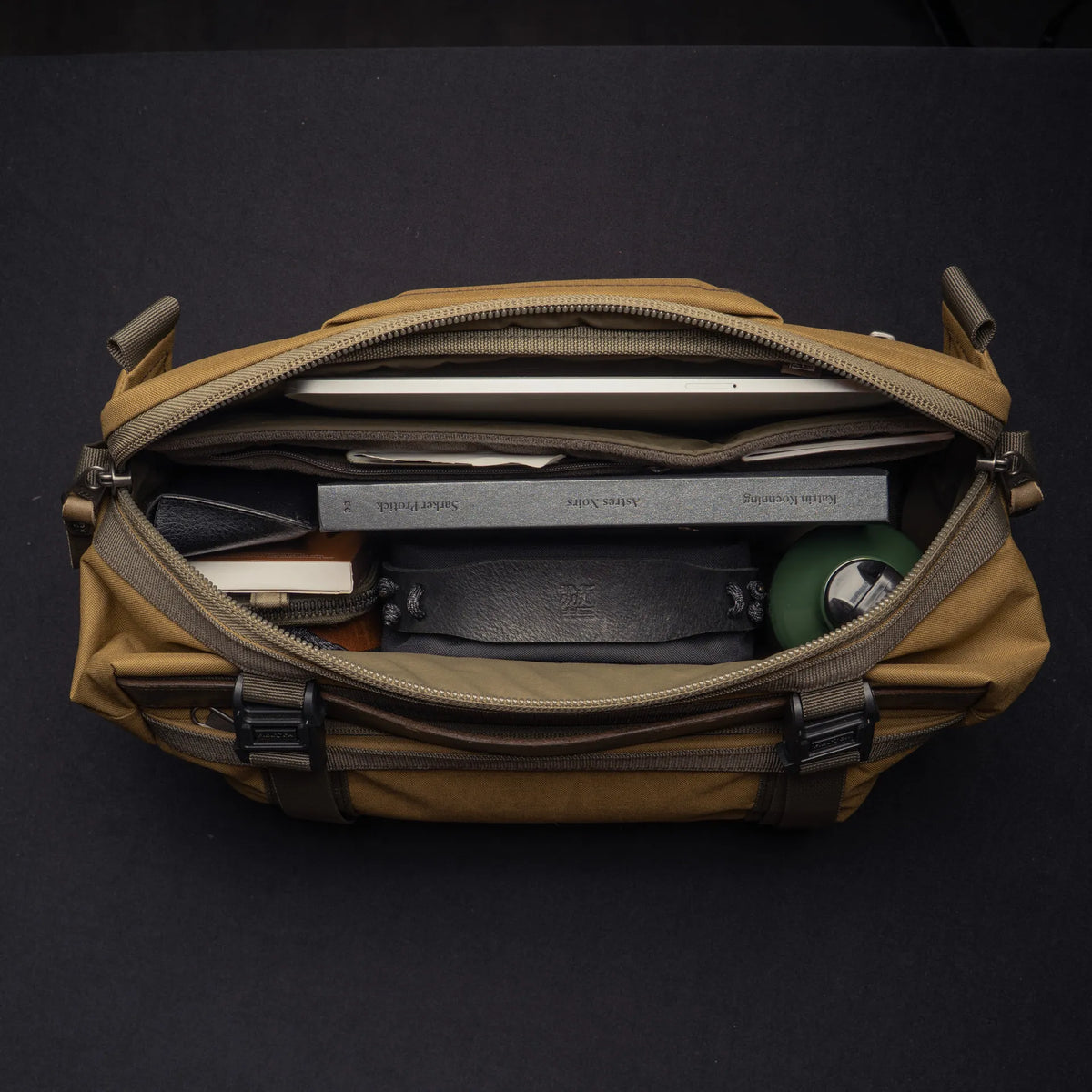 Wotancraft Easy Rider khaki bag open from above with tablet, wallet and bottle