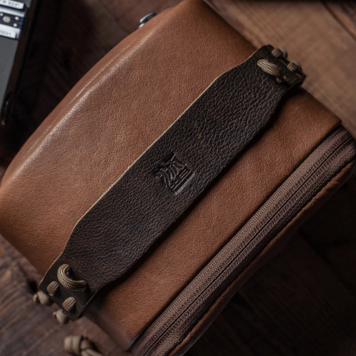 Wotancraft brown leather pouch top strap with embossed logo, from above
