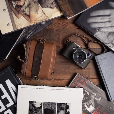 Wotancraft brown leather pouch and olive Leica M among photo books, from above