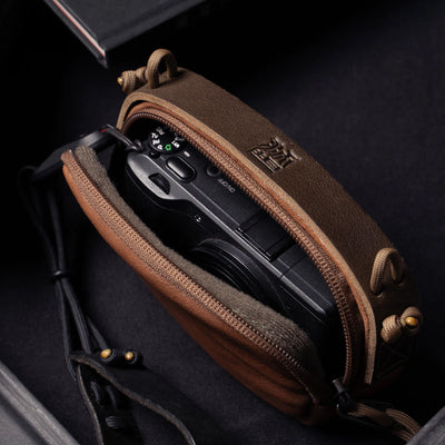 Wotancraft brown leather small pouch open with a Ricoh GR inside