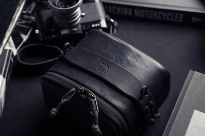 Wotancraft black leather pouch with a Leica M6 and books behind