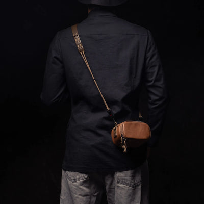 Man wearing the Wotancraft brown leather pouch across the back