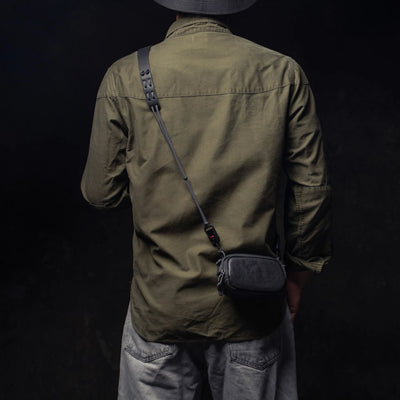 Man wearing the Wotancraft black leather small pouch on a strap, rear view