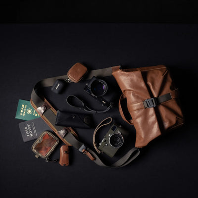 Wotancraft Pilot brown leather bag with Leica cameras, passport and accessories laid out