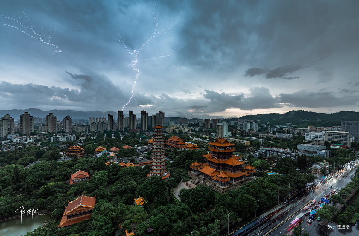 Lightning over a city and pagoda, ultra-wide sample from the TTArtisan 10mm f/2