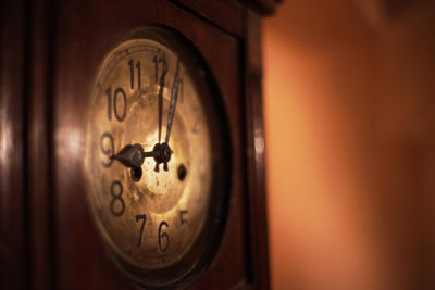 Antique wall clock face in warm light, sample from the Voigtlander Nokton Classic 35mm f/1.4