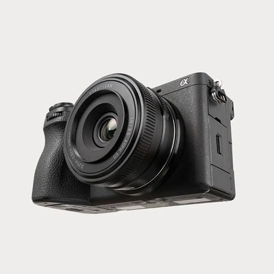 TTArtisan AF 14mm f/3.5 mounted on a black Sony a6700, angled view