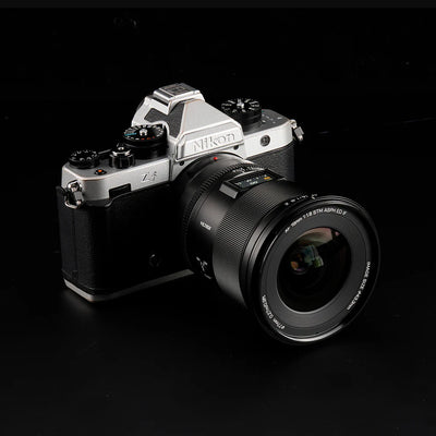 Viltrox AF 16mm f/1.8 Z mounted on a silver Nikon Zf camera, front three-quarter view
