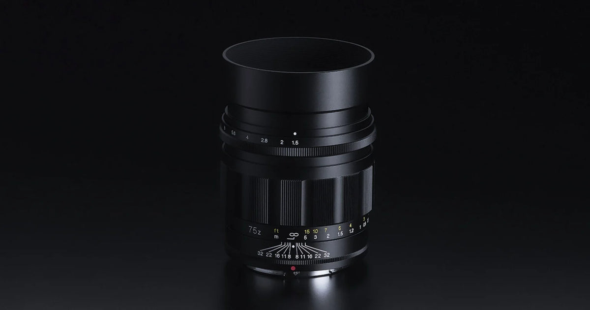 Voigtlander Nokton 75mm f/1.5 Z lens with hood on a dark background
