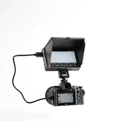 Viltrox DC-X monitor with sunshade mounted on a Nikon camera via HDMI cable