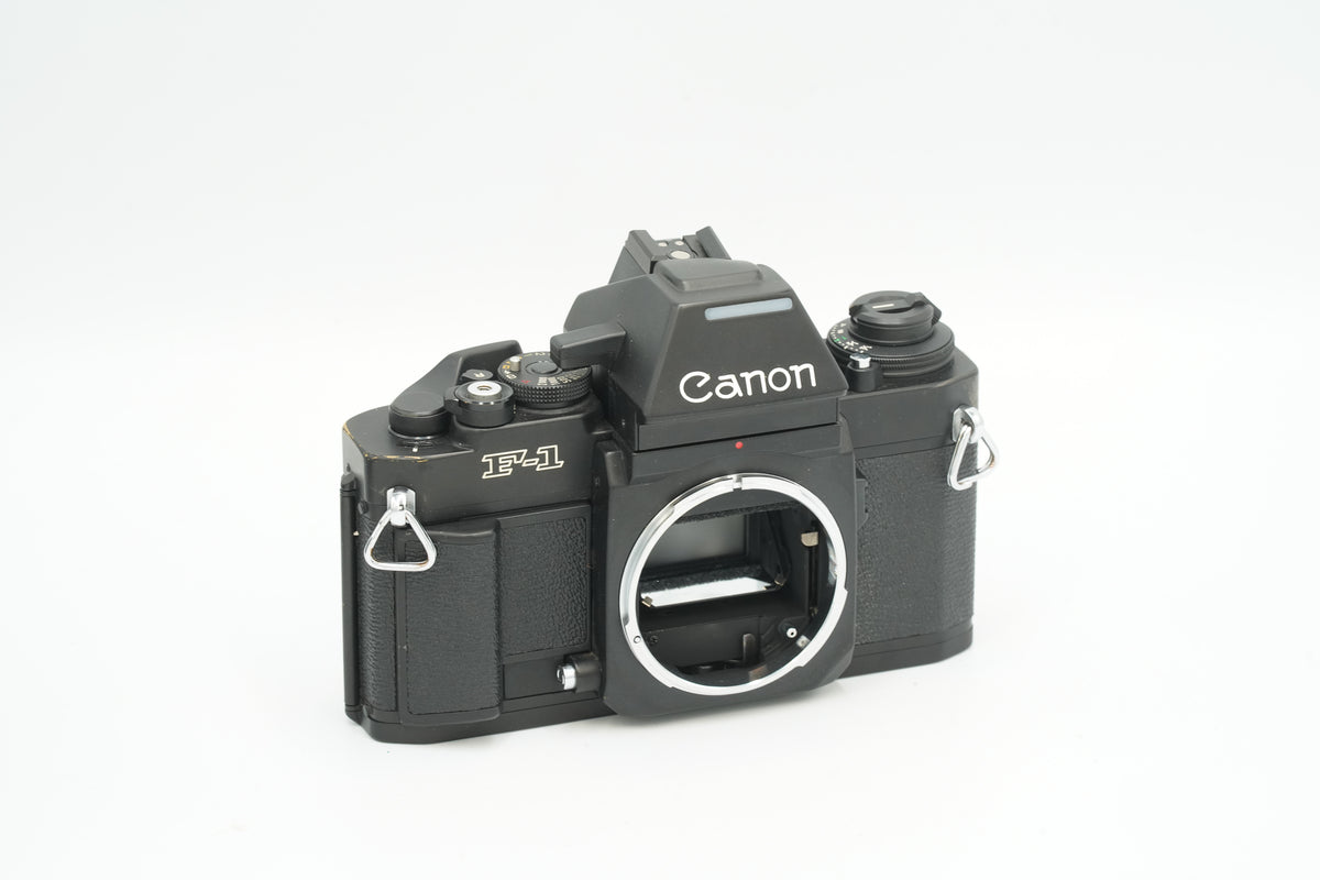 Canon New F-1 black 35mm SLR film camera body, angled front view