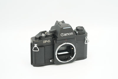 Canon New F-1 black 35mm SLR film camera body, angled front view