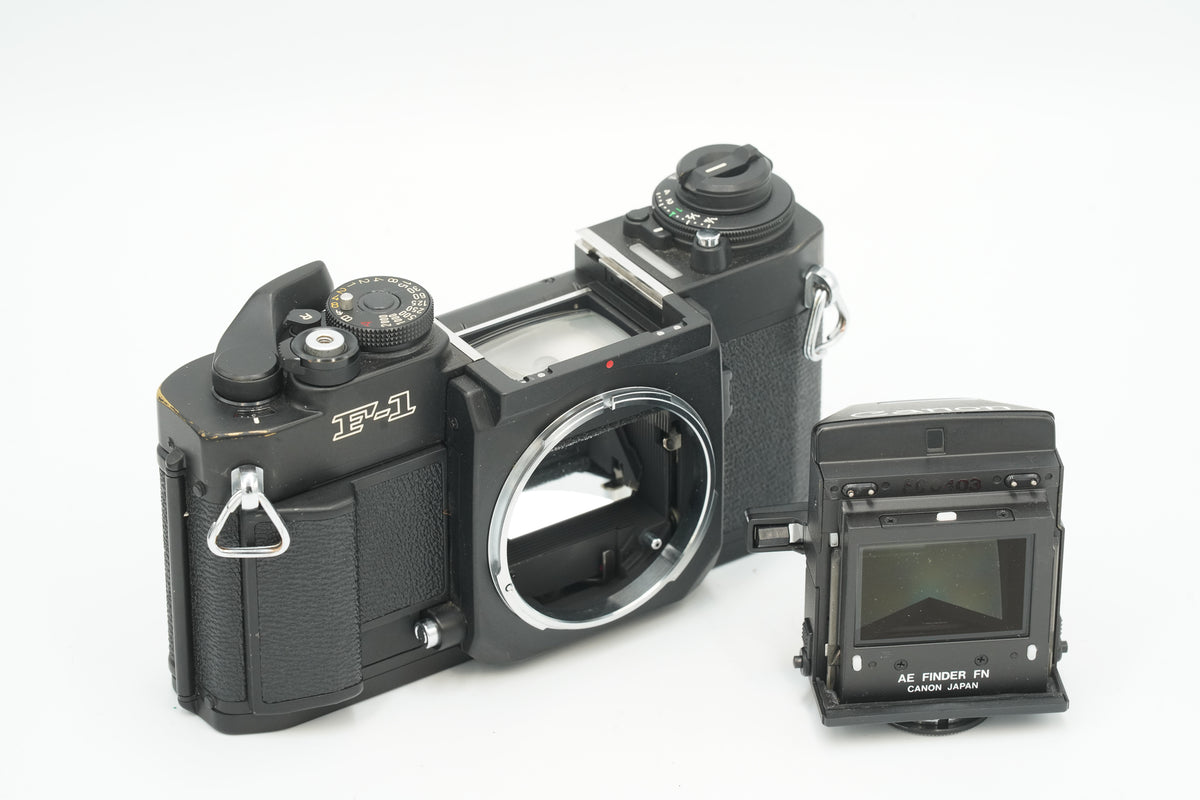Canon New F-1 with its AE Finder FN removed beside the body