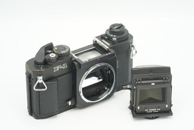 Canon New F-1 with its AE Finder FN removed beside the body