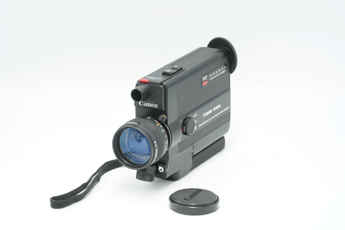 Canon 310XL Super 8 movie camera with lens cap and wrist strap, front three-quarter view
