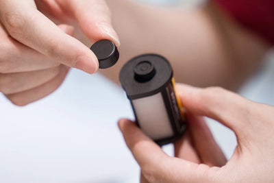 Hands removing the magnetic cap from the TTArtisan mini LED light