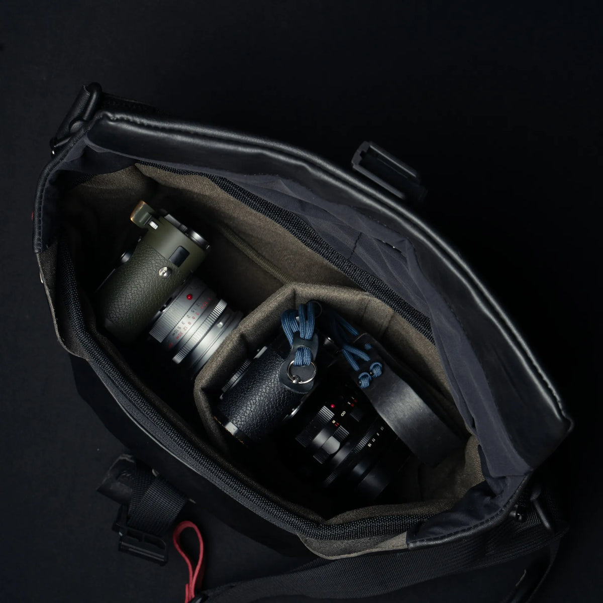 Wotancraft Pilot black leather bag open with two Leica cameras in the padded insert