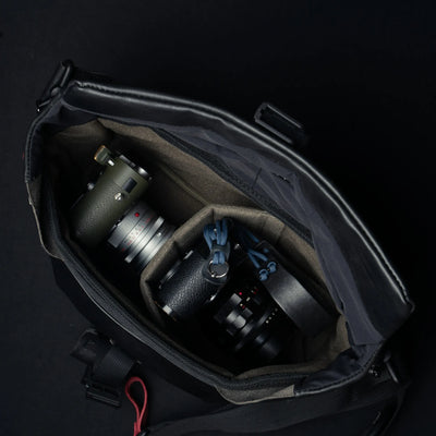 Wotancraft Pilot black leather bag open with two Leica cameras in the padded insert