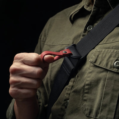 Wotancraft shoulder strap with red leather quick-release pull, worn