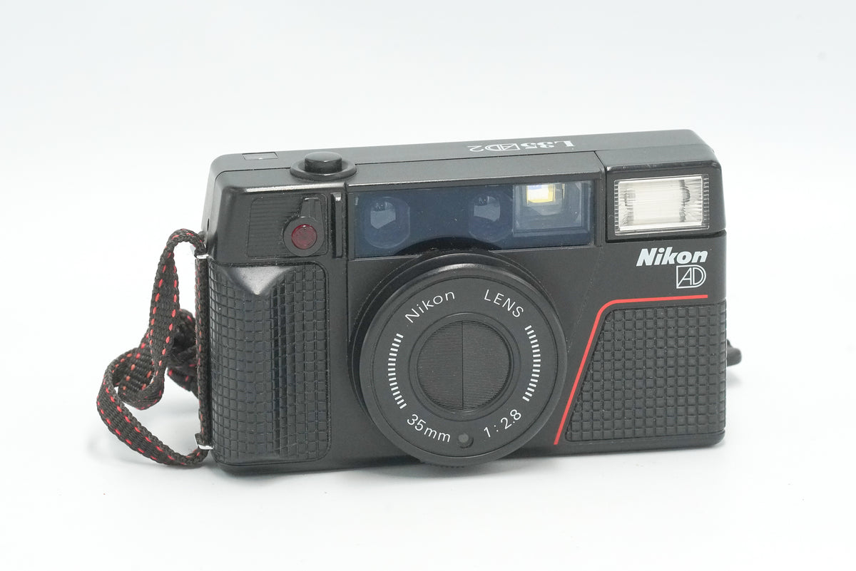 Nikon L35AD2 35mm point and shoot film camera with wrist strap, front view