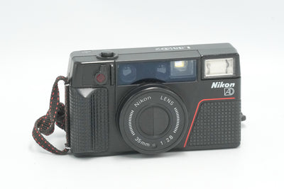 Nikon L35AD2 35mm point and shoot film camera with wrist strap, front view
