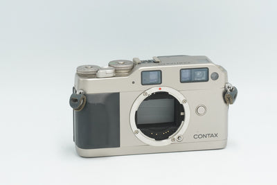 Contax G1 35mm rangefinder film camera body in titanium silver, front view without lens