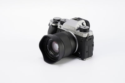 Viltrox Air AF 56mm f/1.7 XF with lens hood on a silver Fujifilm X-T5