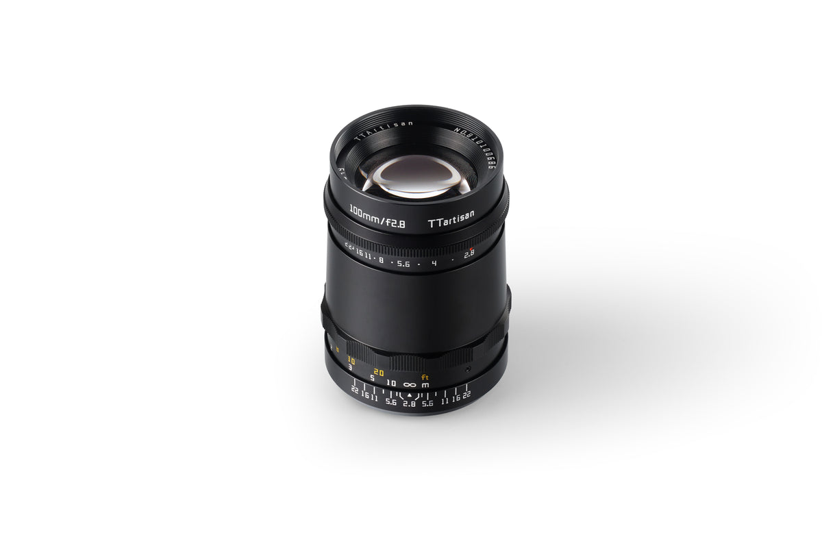 TTArtisan 100mm f/2.8 lens, front three-quarter view on white