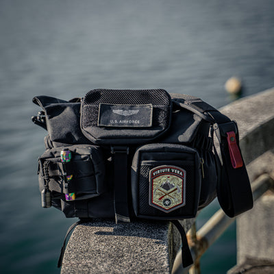 Black camera bag on a railing with Wotancraft Armor pockets and patches
