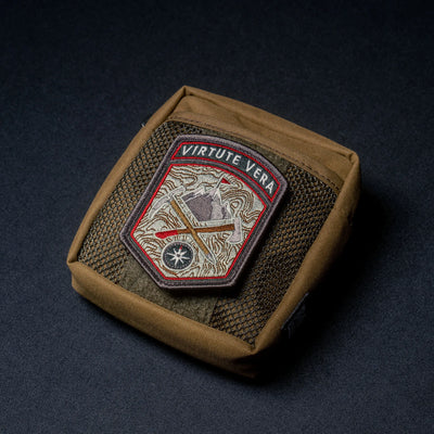 Wotancraft brown Armor 5 pocket with a Virtute Vera patch on the hook-and-loop panel