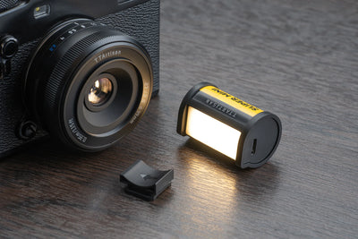 TTArtisan mini LED light switched on next to a camera and its mount